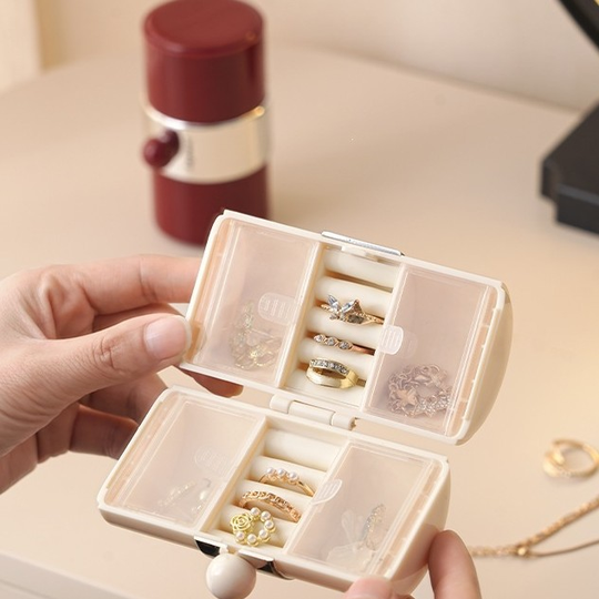 Cream Mini Jewelry Travel Case open in hand