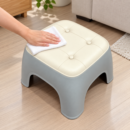 Wiping the cushioned stool seat