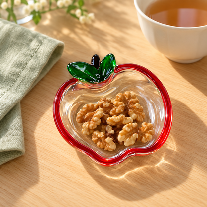 Apple glass dish holding walnuts