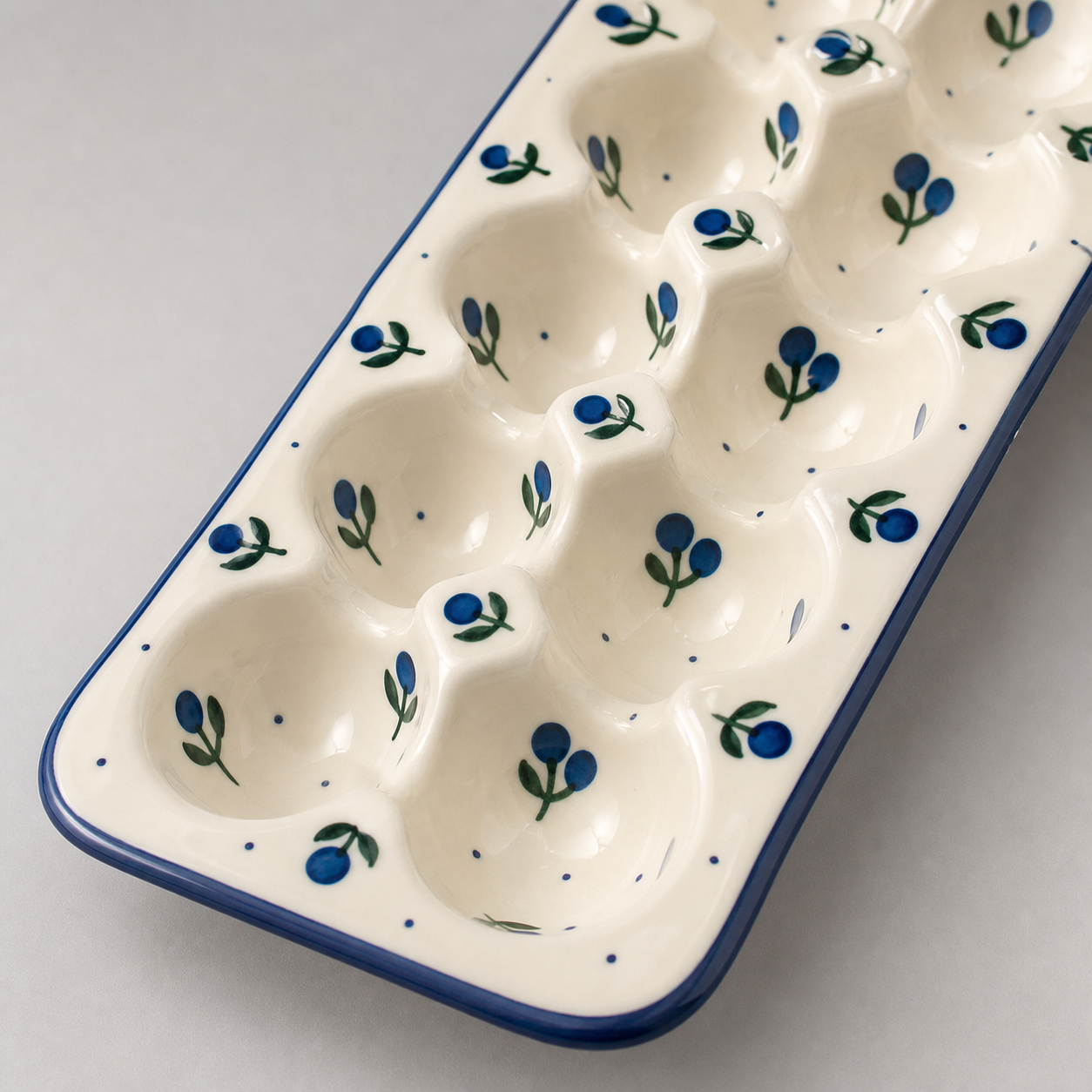 Close view of glossy glaze and blue berry motif