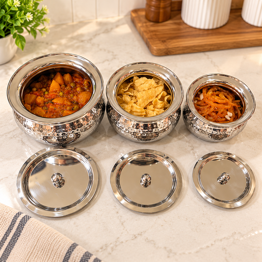 Three open hammered steel handis with matching lids