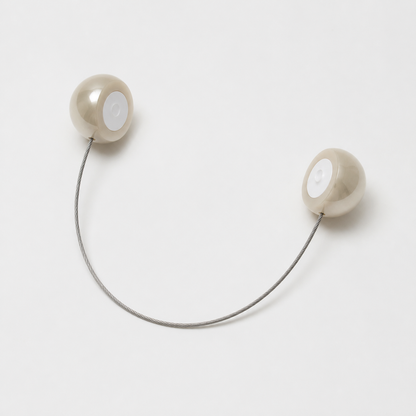 Open magnetic pearl curtain tieback showing two hemispherical clasp halves
