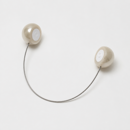 Open magnetic pearl curtain tieback showing two hemispherical clasp halves