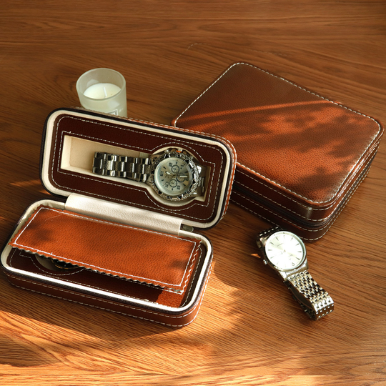 Brown watch storage cases on a wooden surface